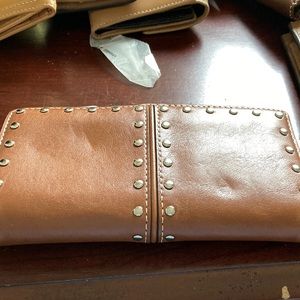 This is a Michael Kors wallet a zipper pouch separates two side pouches